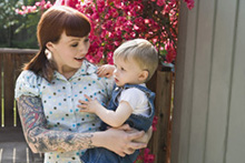 Hipster woman with tattoos and child